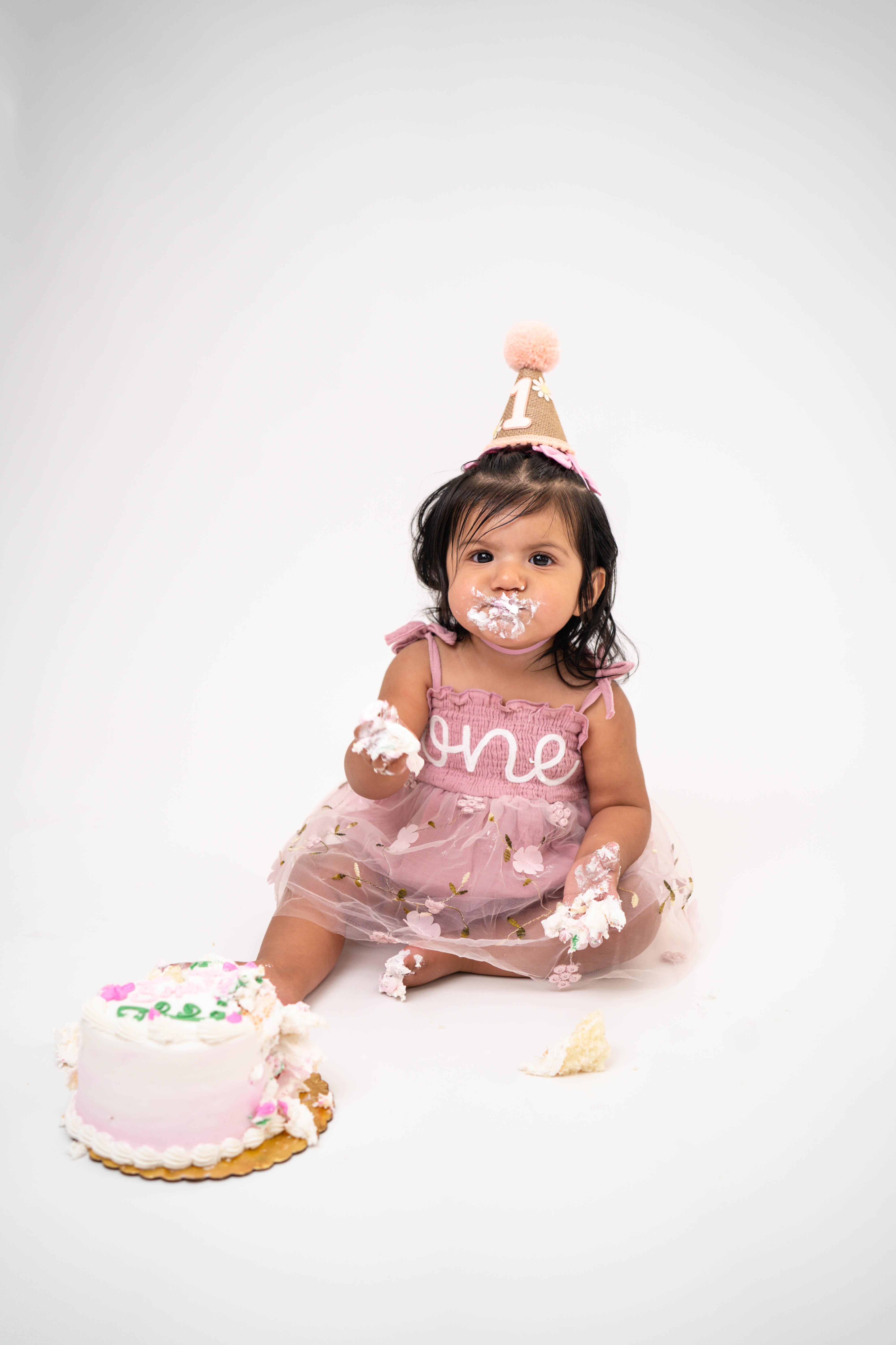 Child celebrating a milestone birthday during a Solano County cake smash session.