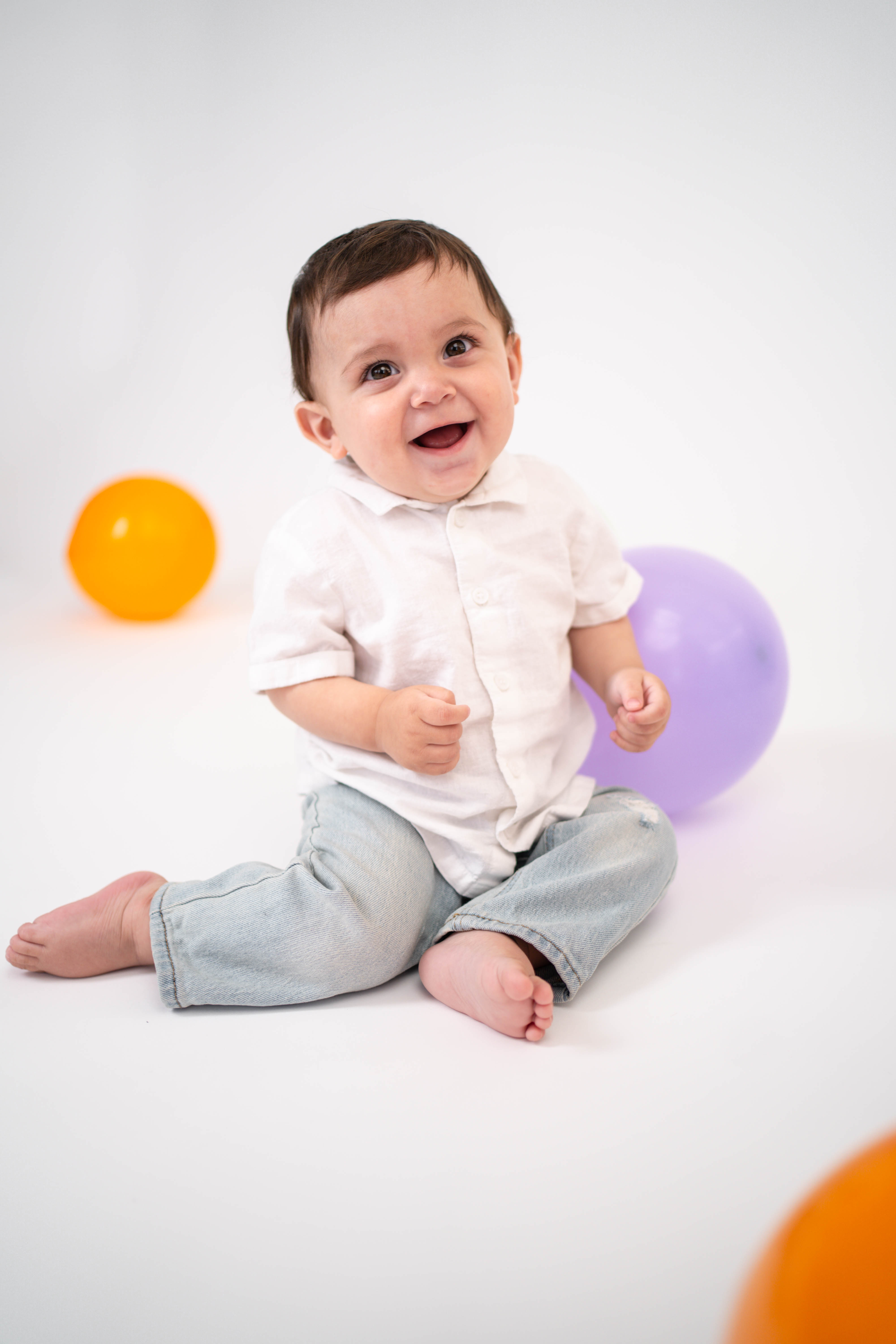 Toddler smiling beside a birthday setup during a Vacaville milestone photography session.