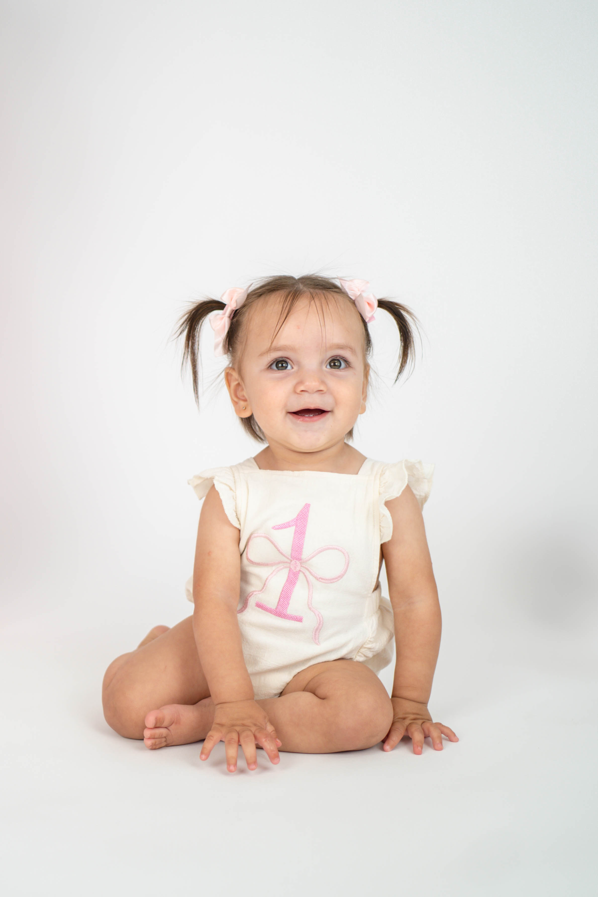 Child playing with cake during a first birthday photo session in Vacaville.