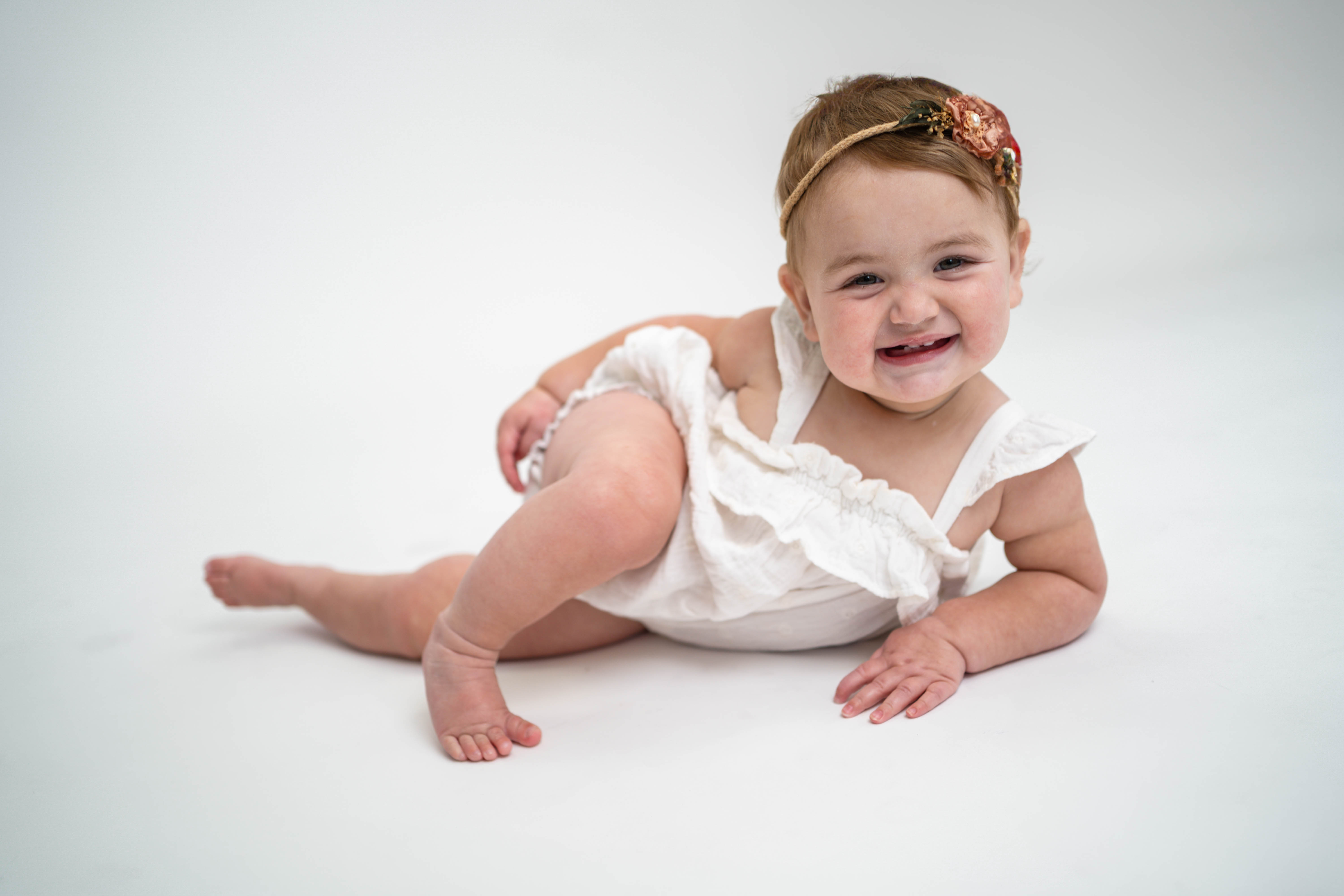 Child smiling outside in soft natural light during a Vacaville family portrait session.